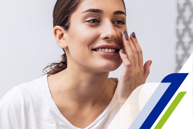 Girl in front of a mirror with her hands on her face Girl in front of a mirror with her hands on her face