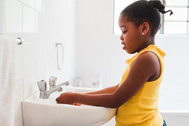 Menina lavando as mãos de uma maneira divertida Menina lavando as mãos de uma maneira divertida