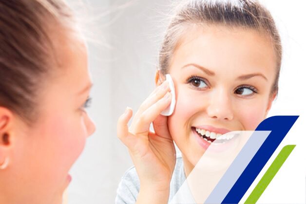 Girl in front of a mirror taking care of her skin Girl in front of a mirror taking care of her skin